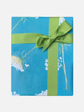 Gift box wrapped in blue Queen Anne's lace floral paper with a green ribbon bow