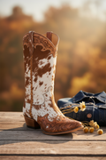Cowboy boot with brown and white pattern on a white background