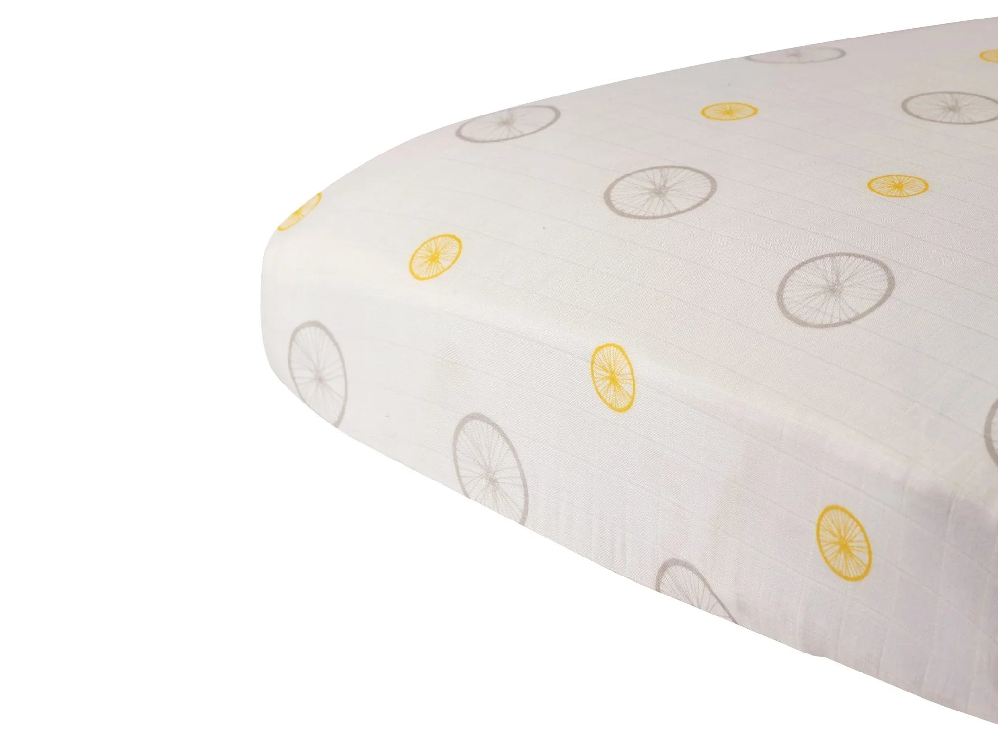 Bamboo crib sheet with yellow and gray wheel pattern, eco-friendly nursery bedding.