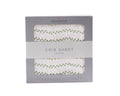 Newcastle Classics cotton crib sheet with green plant pattern, boxed for gift shop display