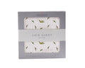 Newcastle Classics cotton crib sheet in gift box, featuring green dinosaur print