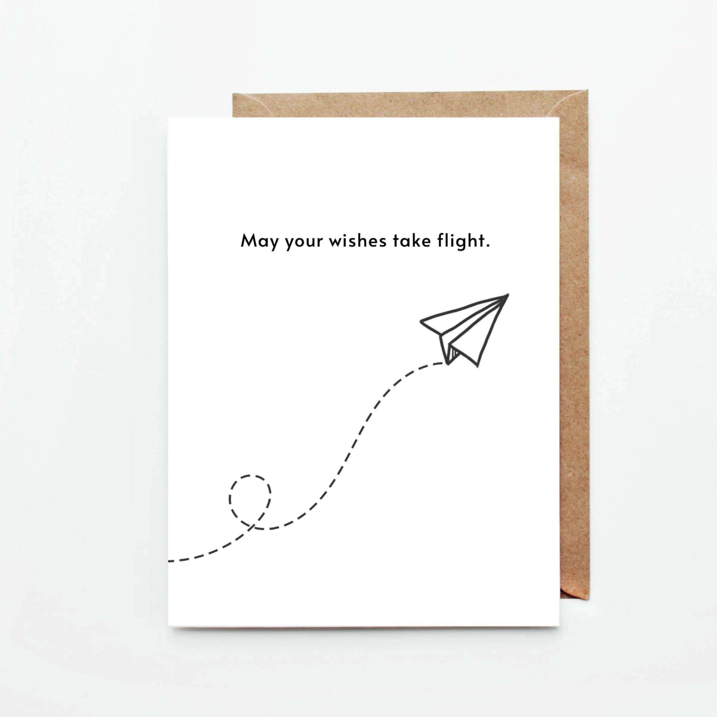 Minimalist white greeting card with a paper airplane and text May your wishes take flight