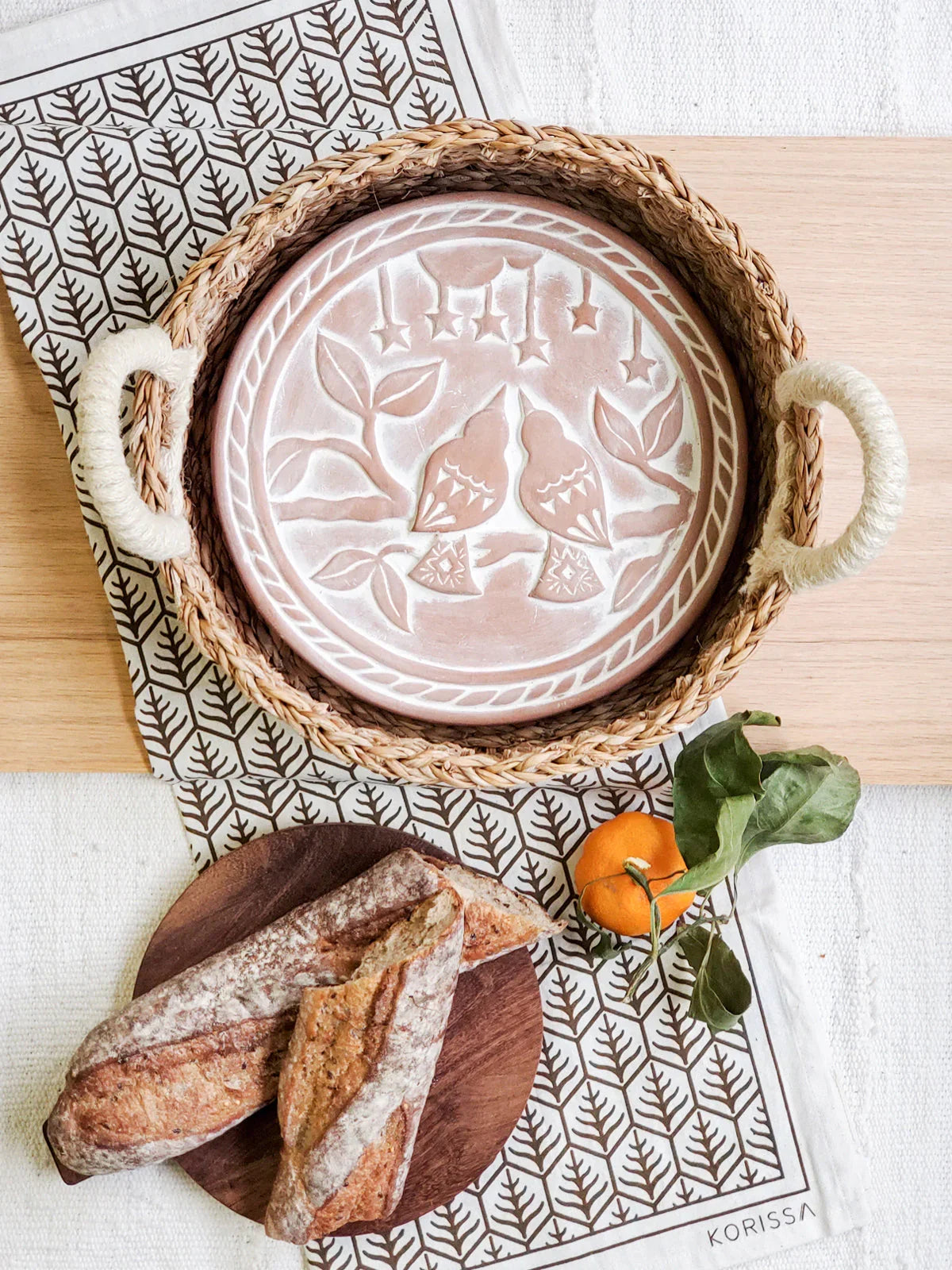 Handcrafted lovebird design bread warmer basket with rustic bread and orange, Qu!rk Boutique gift.