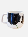 White ceramic mug with handle featuring black floral design and green stem on a white background