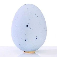 Light blue speckled egg-shaped decor on display, Qu!rk Boutique artisan gift shop style