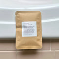 Herbal facial steam treatment pouch on a bathroom counter, eco-friendly skincare product