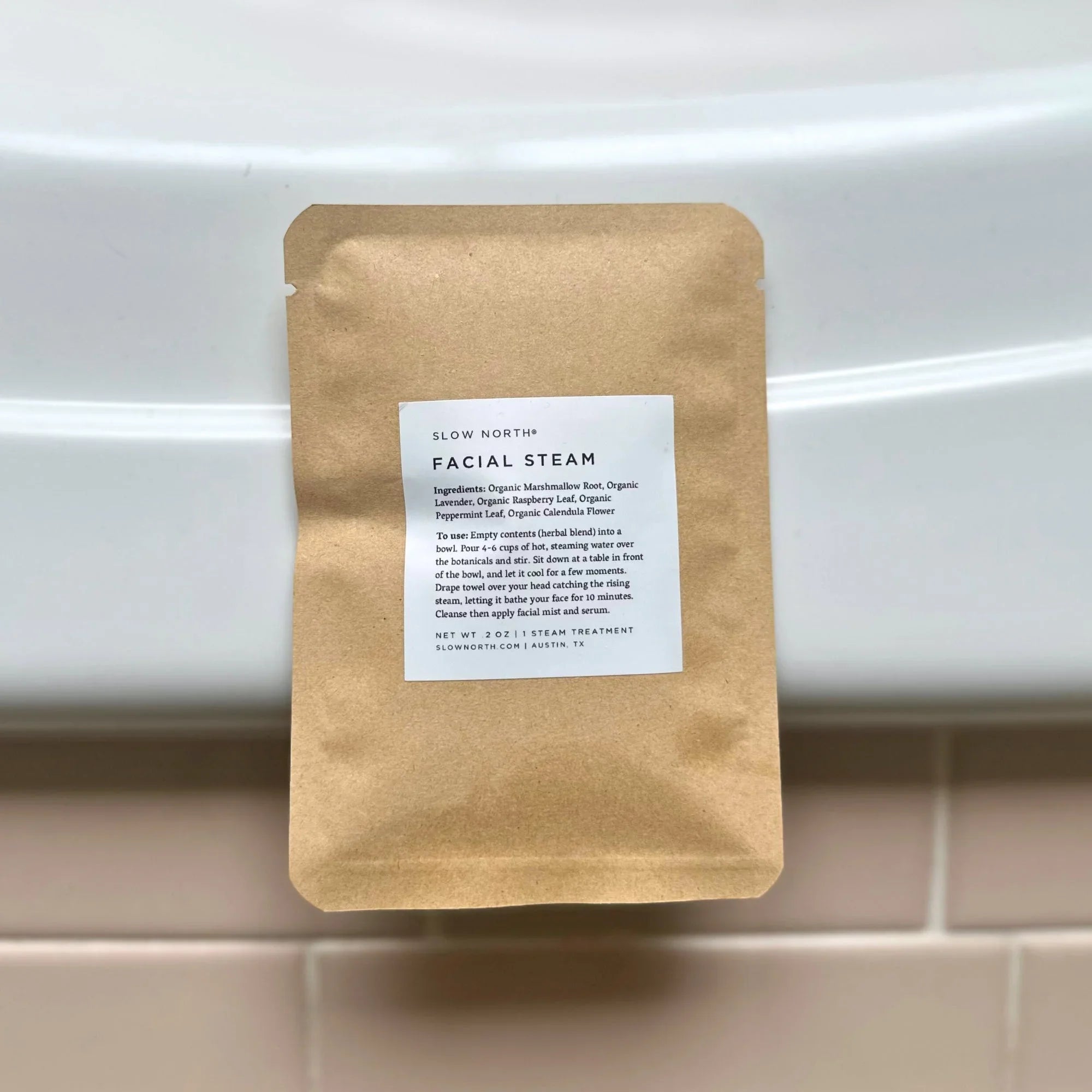 Herbal facial steam treatment pouch on a bathroom counter, eco-friendly skincare product