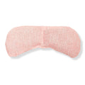 Pink and white striped woven pattern weighted eye mask on white background