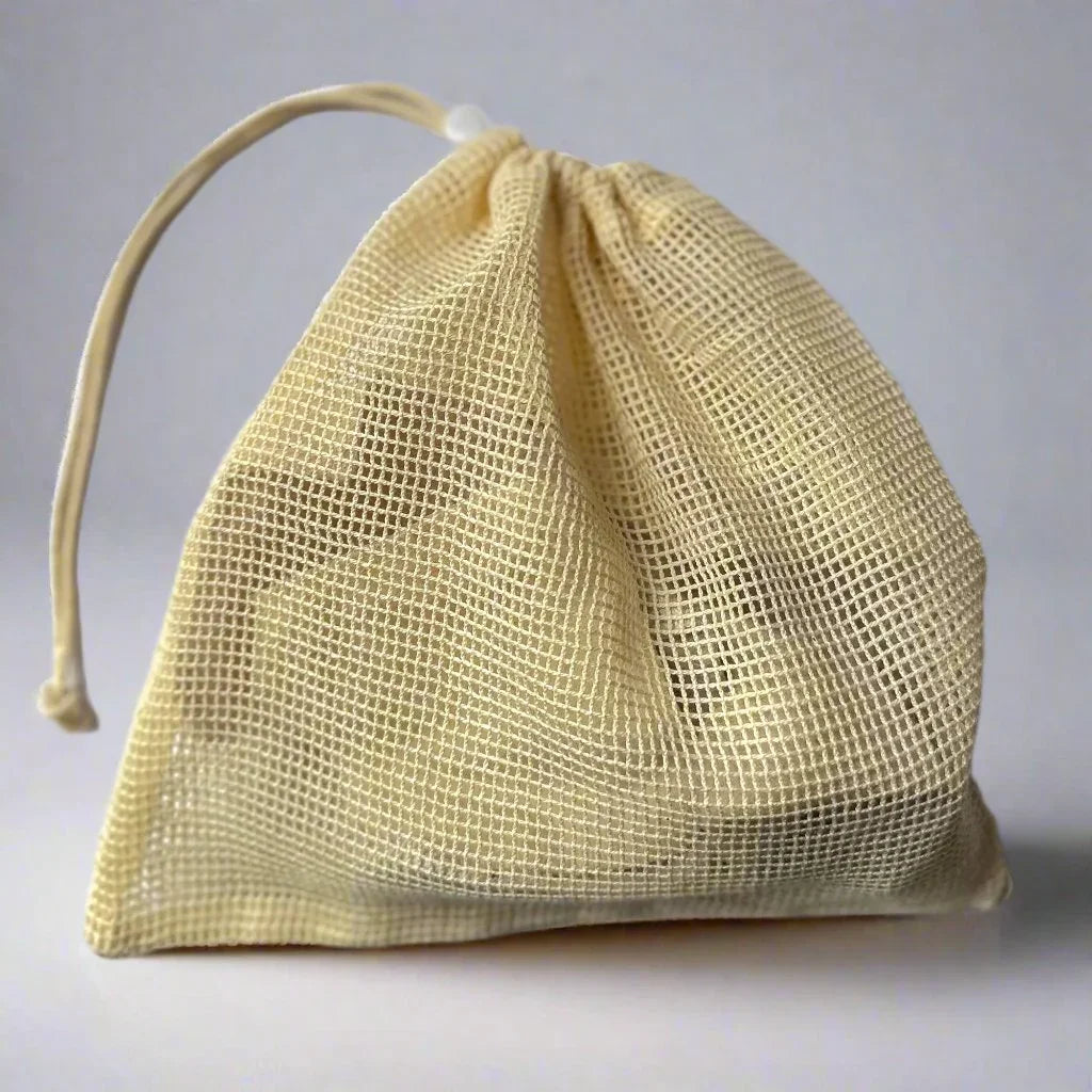 Small beige mesh laundry bag with drawstring closure on a plain background