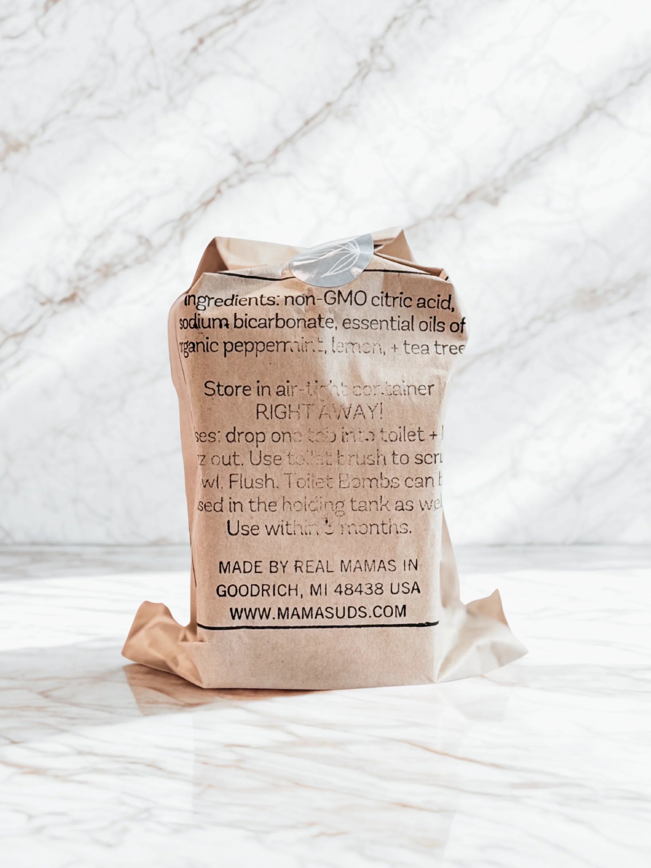 Eco-friendly refill bag with ingredient list, set on marble, at Qu!rk Boutique & Gift Shop