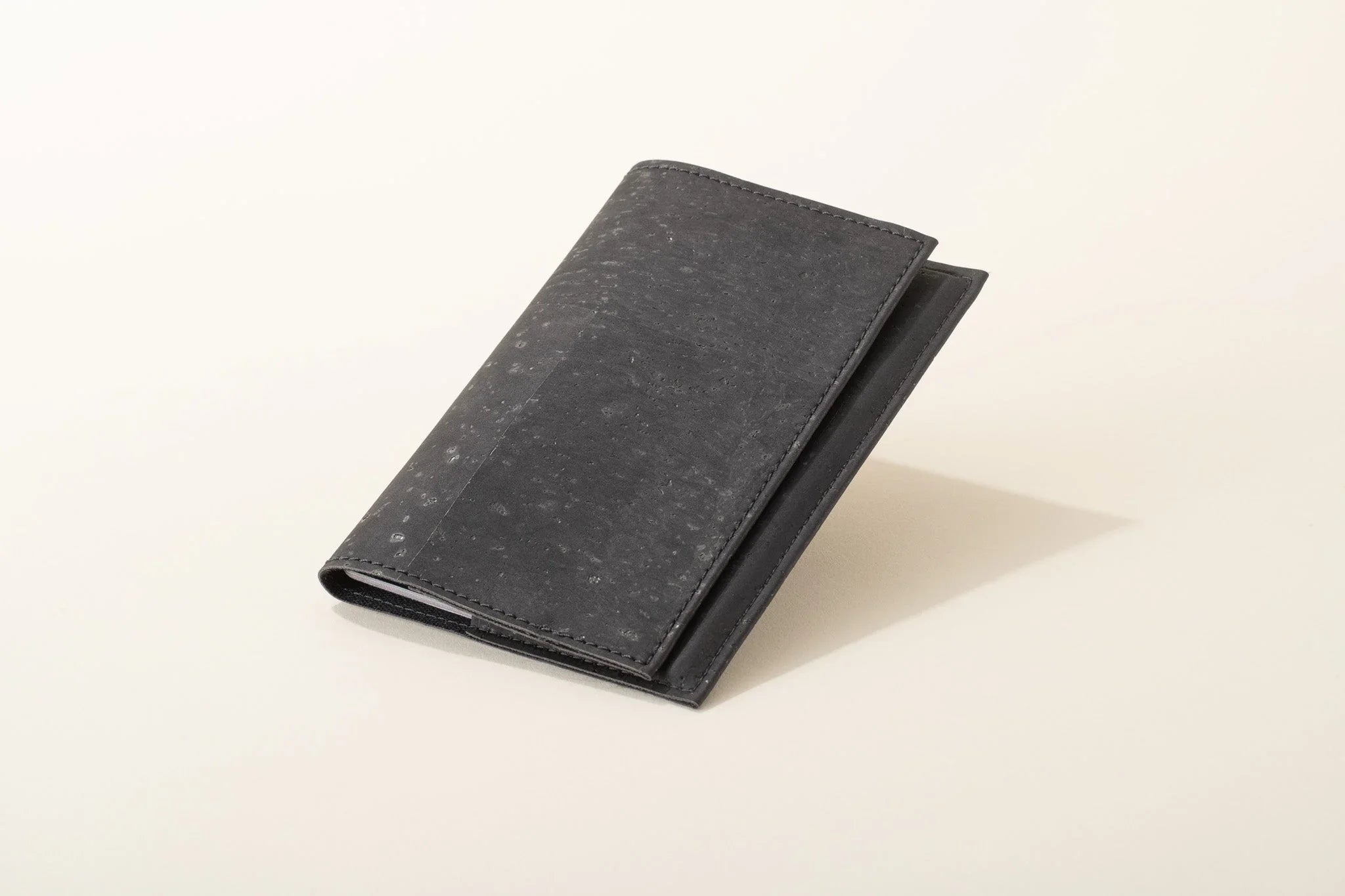 Sleek black vegan cork wallet on neutral background, sustainable fashion at Qu!rk Boutique