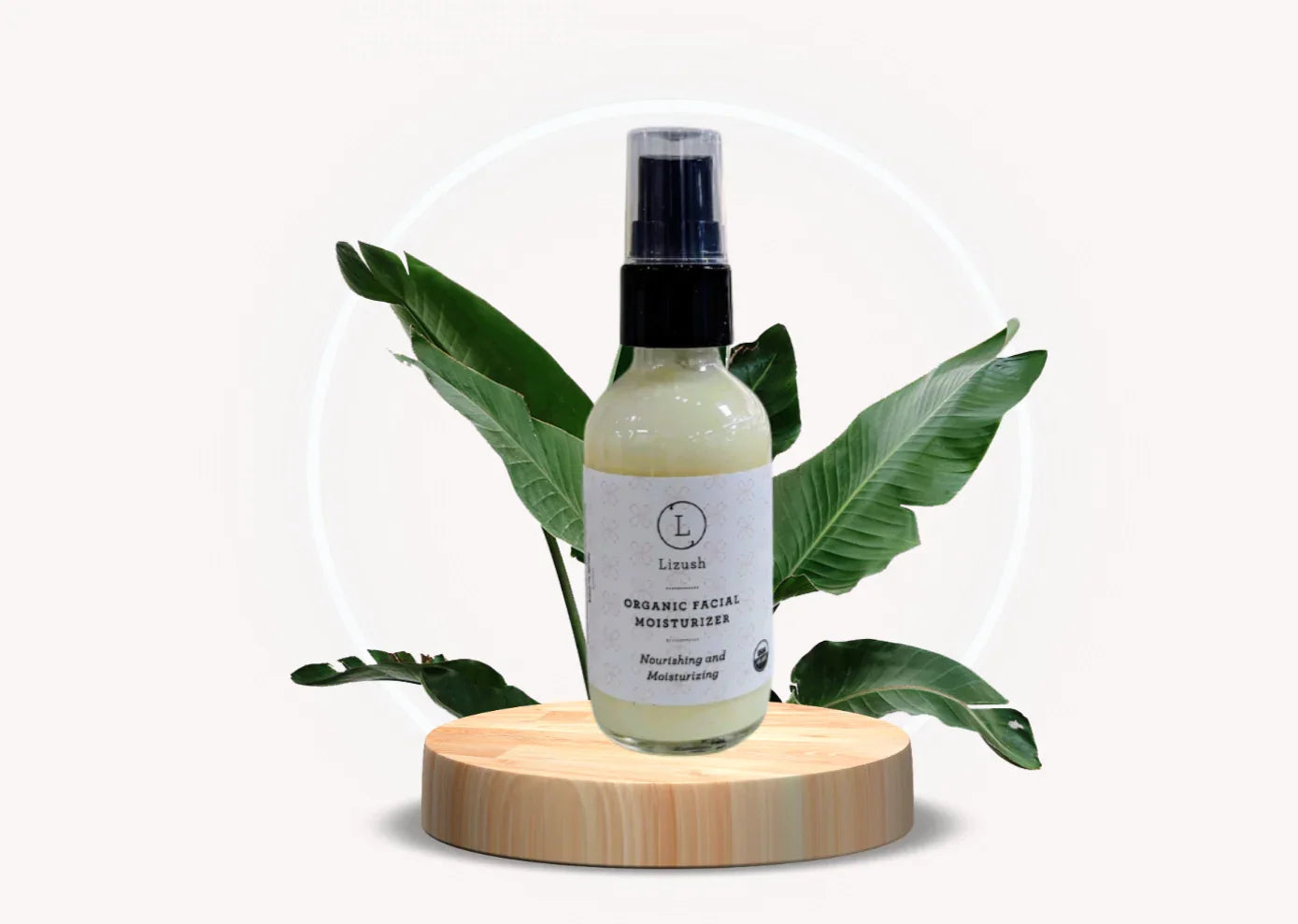 Lizush organic facial moisturizer bottle on wooden stand with green leaves background