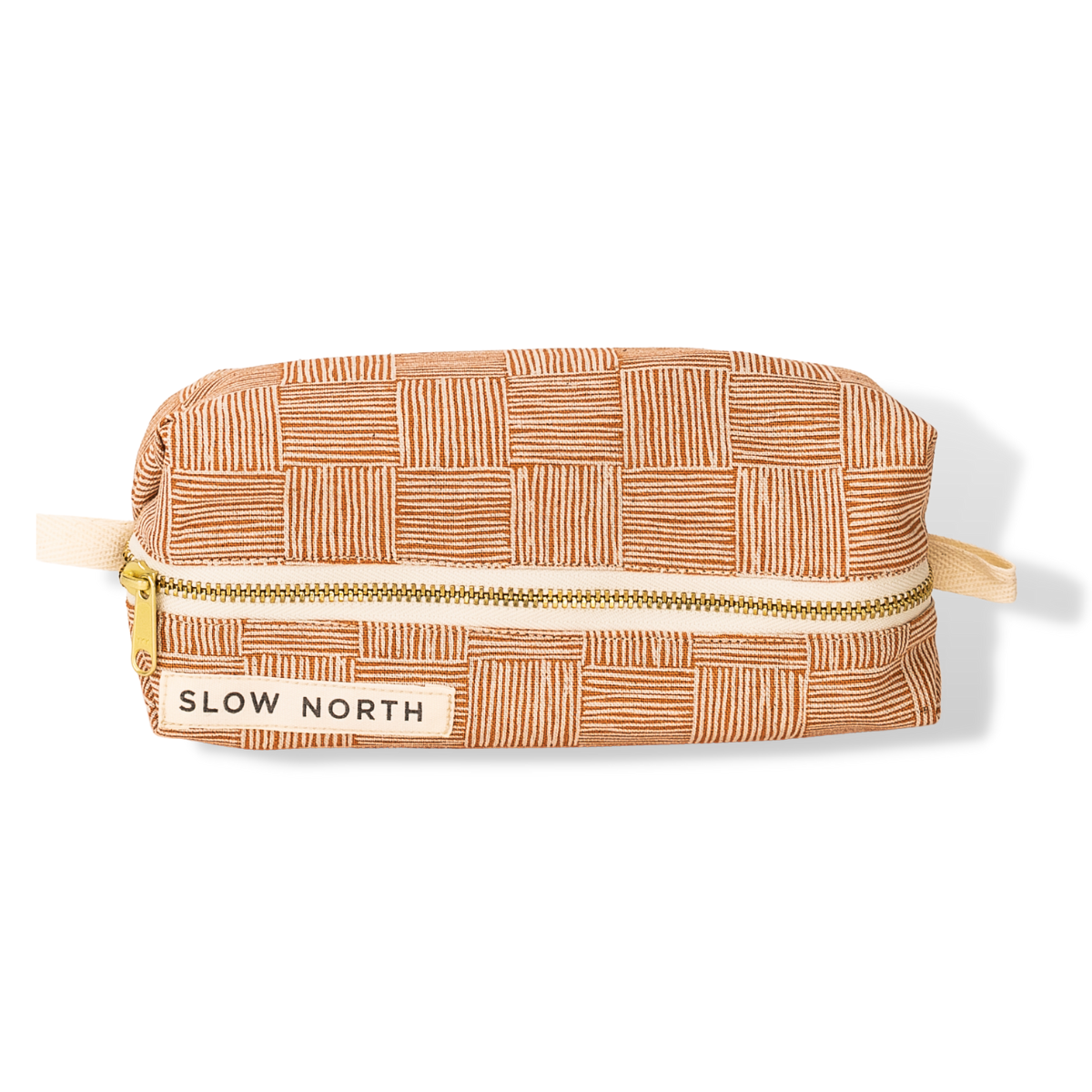 Copper Fields patterned travel pouch with gold zipper and Slow North label, rectangular shape