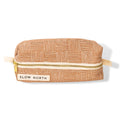 Artist-designed copper travel pouch with geometric pattern and gold zipper, Slow North label