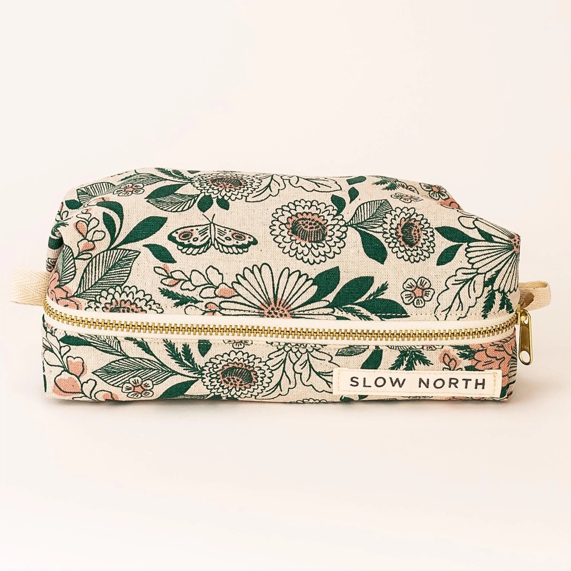 Floral print travel pouch with green and pink flowers and gold zipper by Slow North