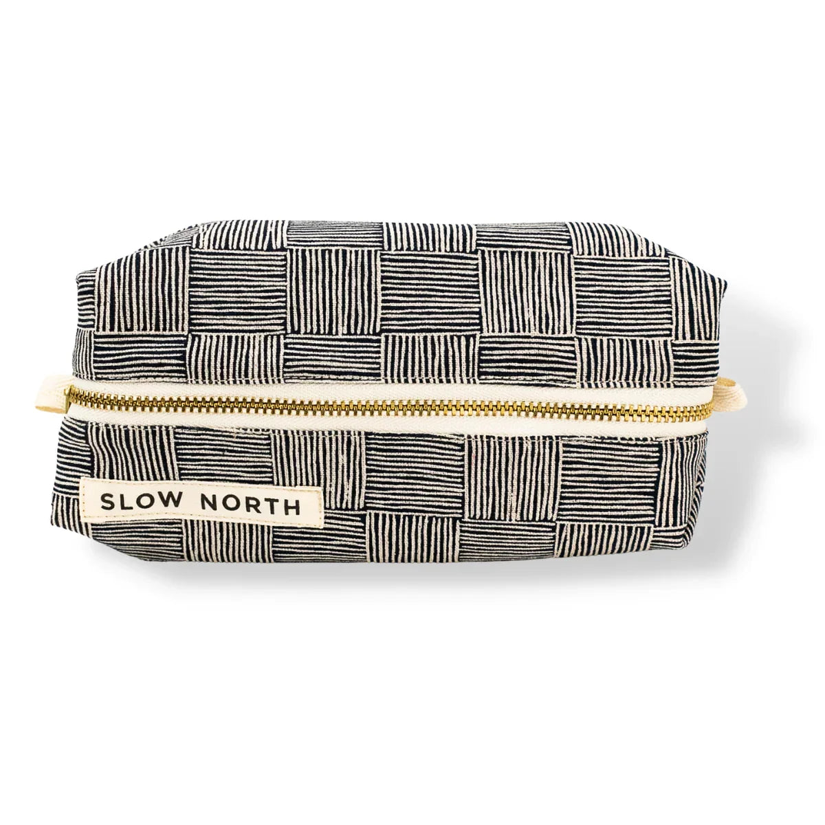 Slow North travel pouch with black and white striped checkered pattern and gold zipper