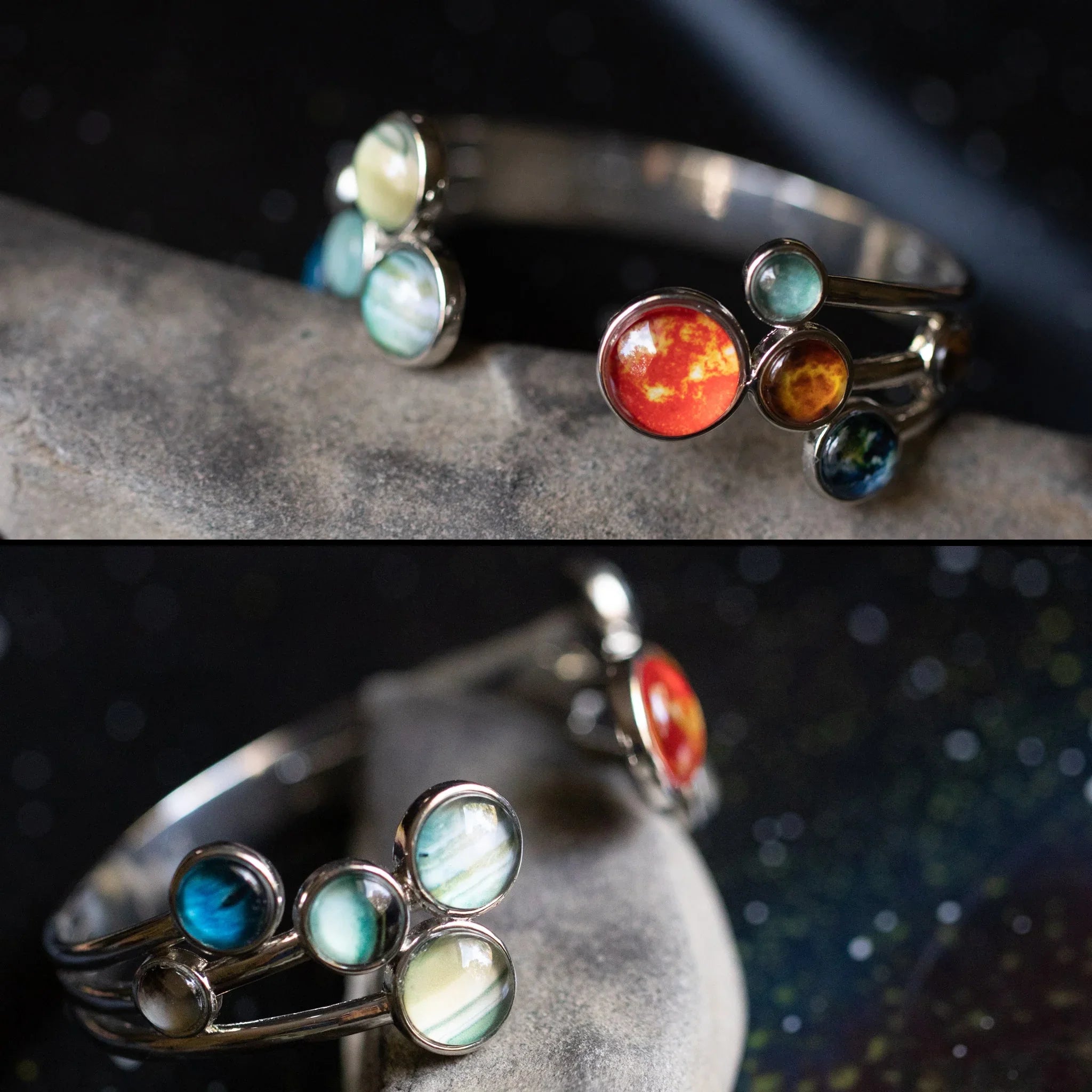 Silver cuff bracelet featuring vibrant glass beads resembling planets on a stone surface with a dark starry background