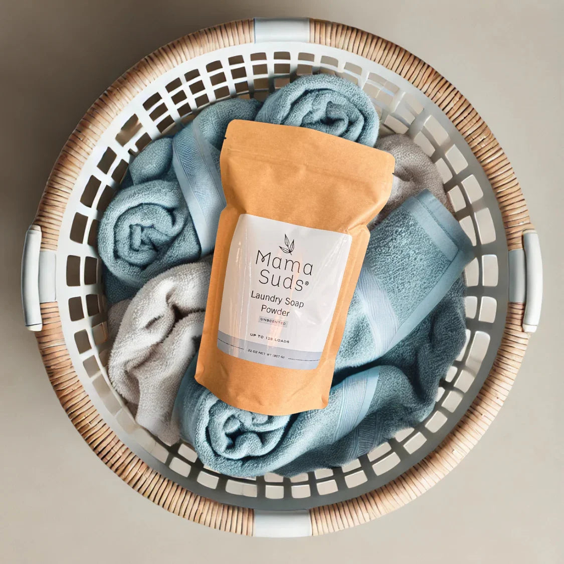 Eco-friendly Mama Suds laundry soap powder in a basket with soft blue towels at Qu!rk Boutique