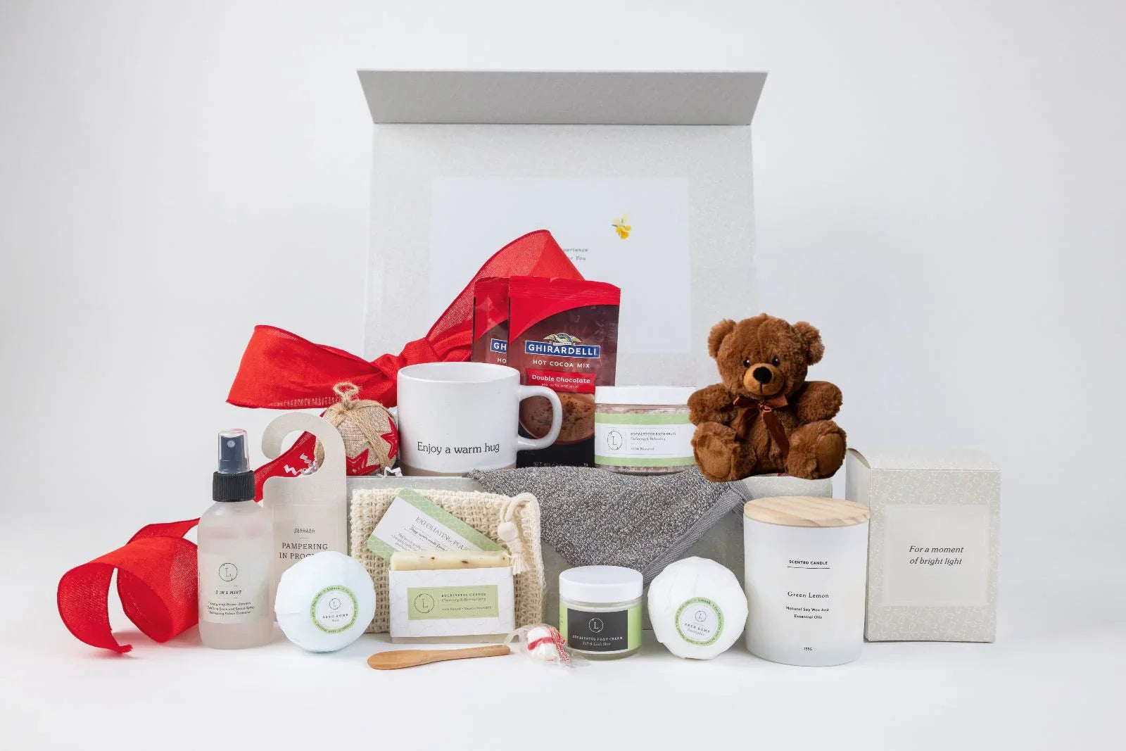 Valentine's gift box with teddy bear, mug, hot cocoa, candle, bath bombs, cream, and spa products