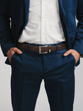 Navy blue suit and white shirt styled with a brown belt from Qu!rk Boutique