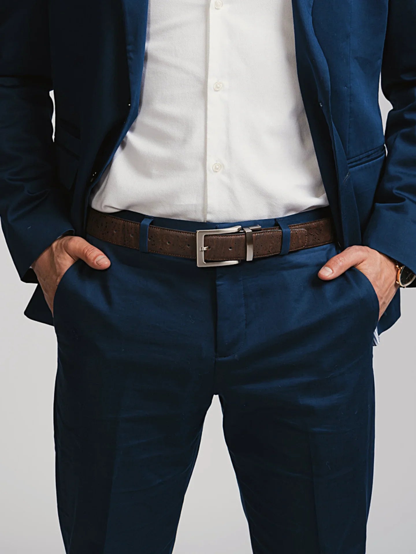 Navy blue suit and white shirt styled with a brown belt from Qu!rk Boutique