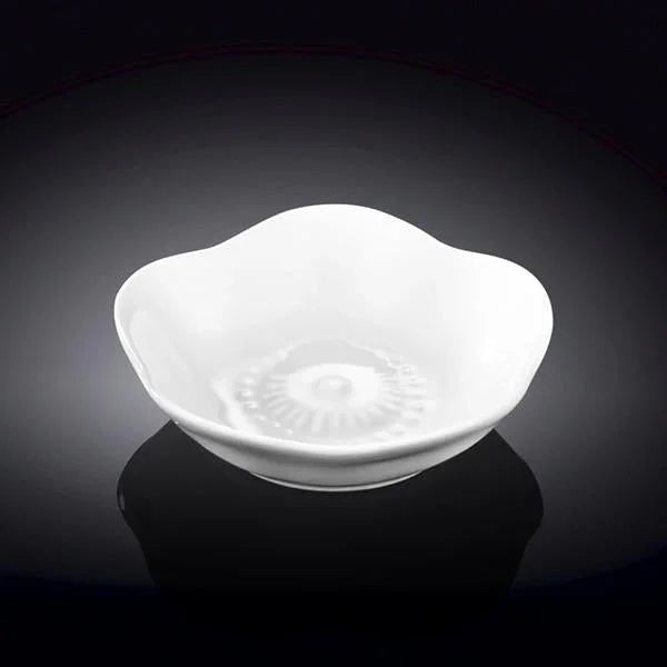 White artist-designed ceramic bowl with a wavy rim and textured center on a black background