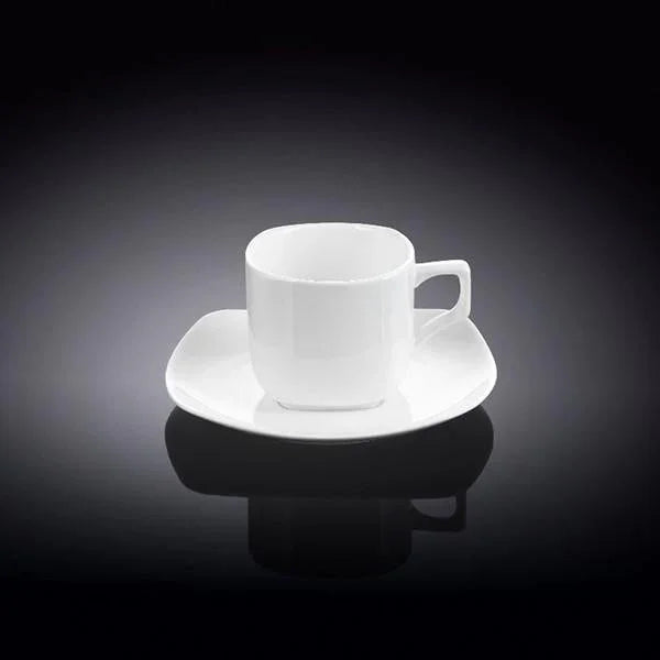 Modern white porcelain coffee cup with matching saucer on a reflective black surface