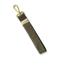 Olive green fabric wristlet with gold clasp and Slow North label