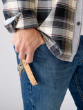 Person in plaid shirt and jeans holding keys with cork strap eco keychain, Qu!rk Boutique
