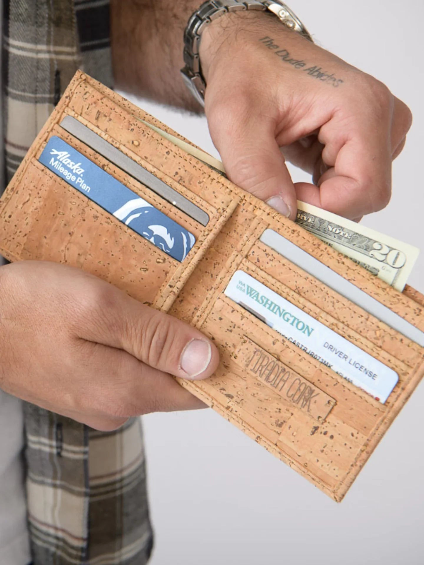 Hand holding eco-friendly cork wallet with cards and cash, Qu!rk Boutique sustainable gift