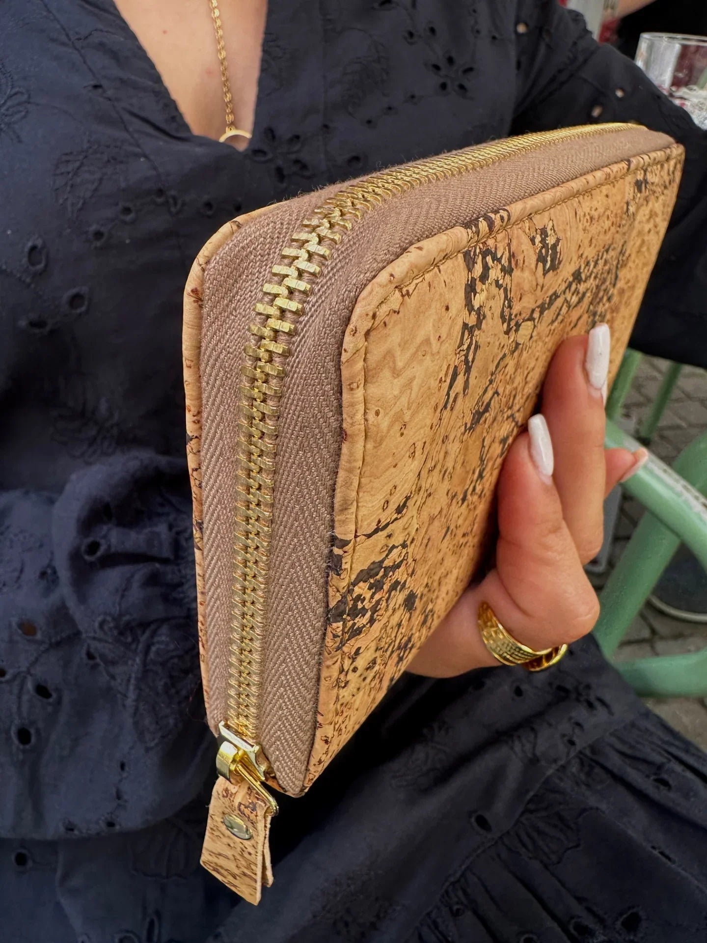 Woman holding eco-friendly cork wallet with gold zipper, Qu!rk Boutique sustainable fashion