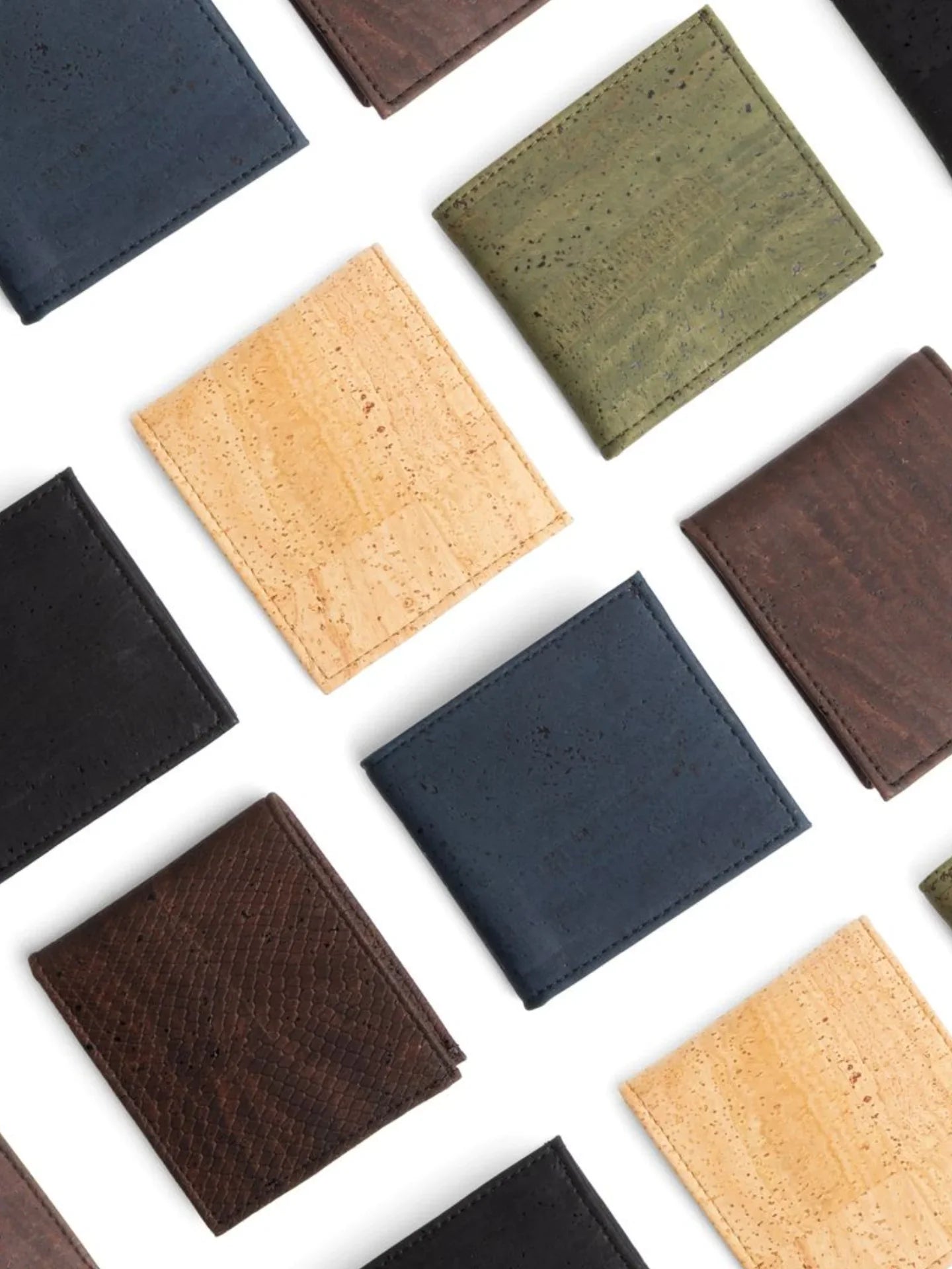 Assorted sustainable cork wallets in brown, black, green, blue, and natural shades on white background.