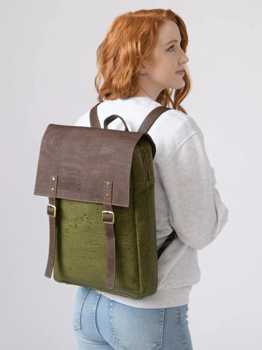 Woman wearing a sustainable olive green and brown backpack, casual boutique style.