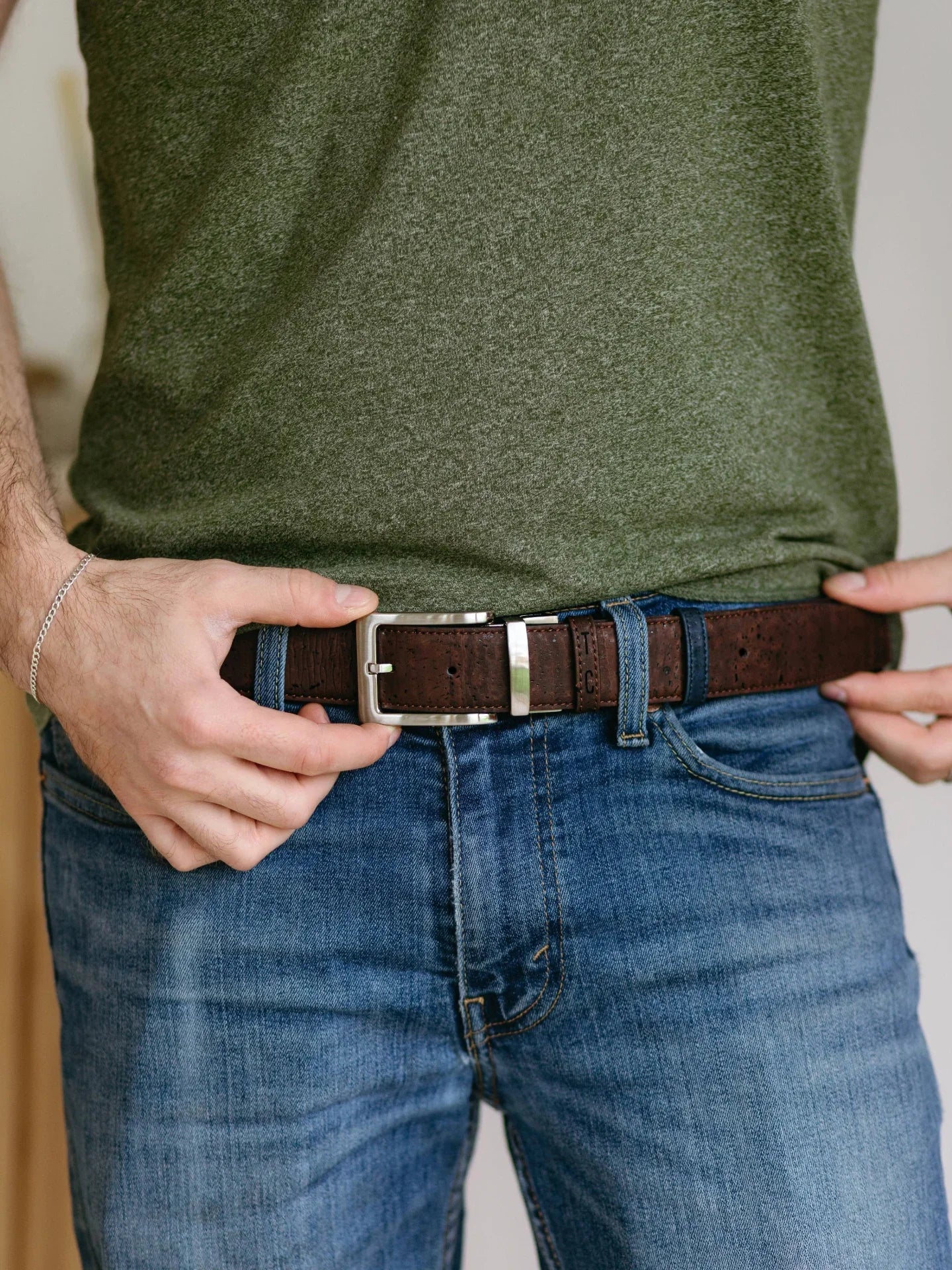 Sustainable brown cork belt with silver buckle on blue jeans, Qu!rk Boutique eco fashion