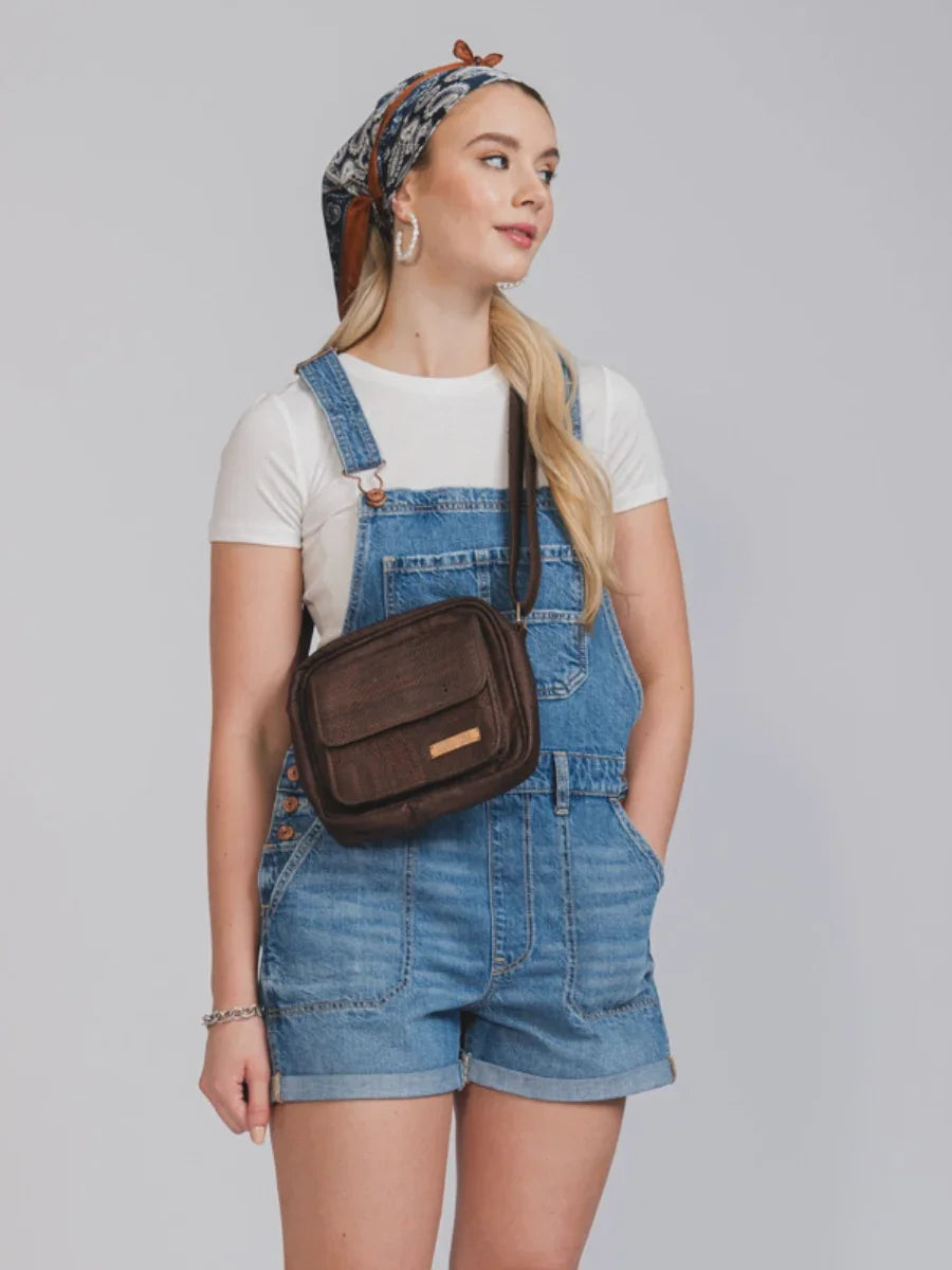 Woman in denim short overalls, white t-shirt, patterned headscarf, and crossbody bag, Qu!rk Boutique style