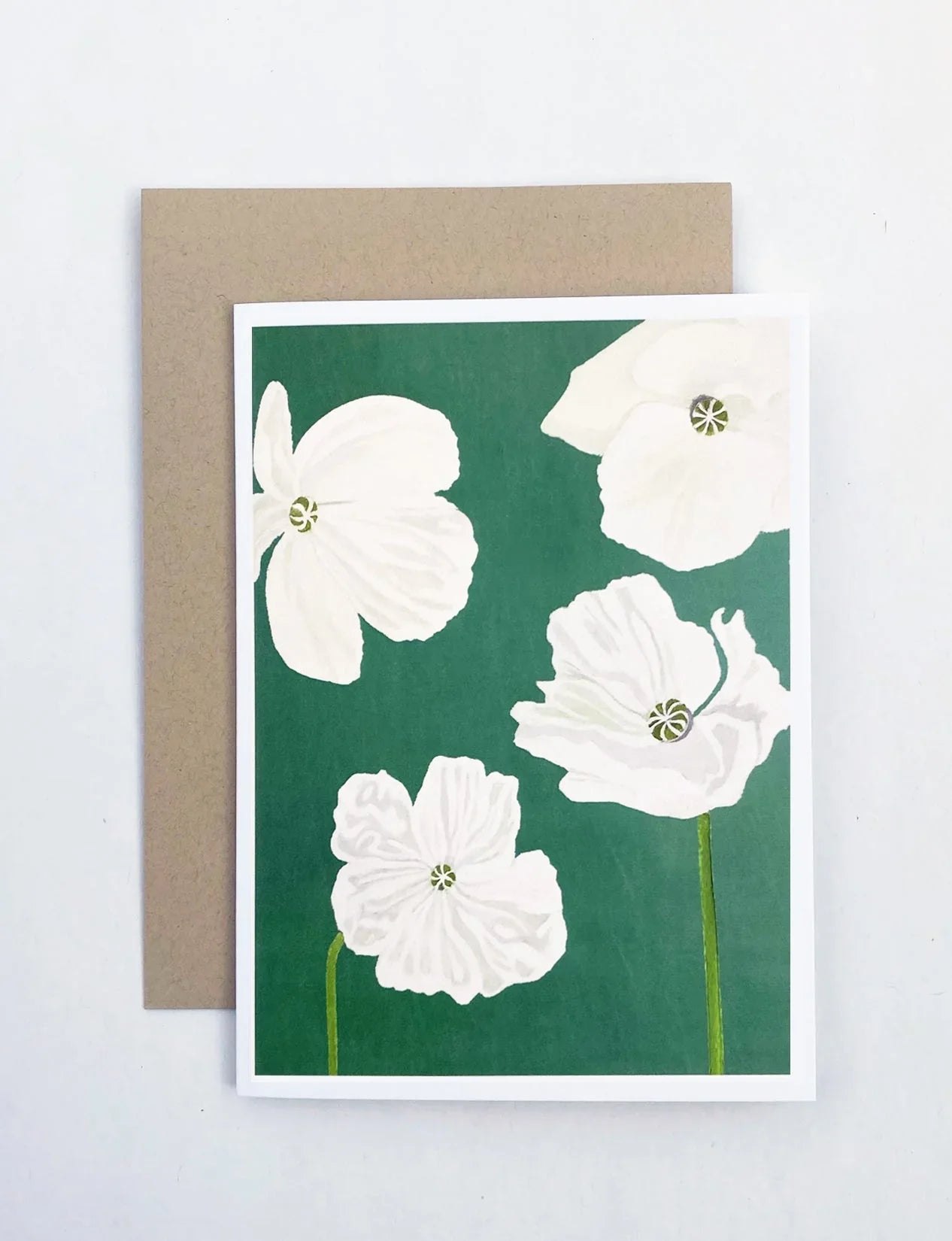Notecard with white poppy flowers illustration on emerald green background, kraft envelope