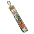 Floral fabric wristlet keychain with gold clip and Slow North label on white background