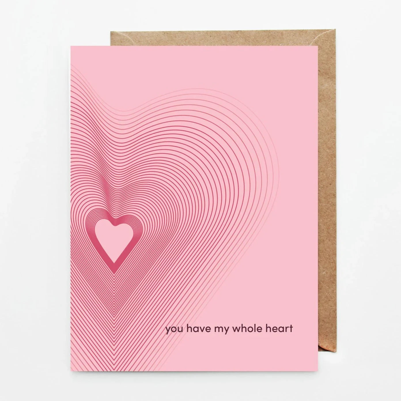 Pink greeting card with concentric heart design and text you have my whole heart