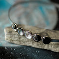 Artist-designed cosmic moon phase necklace on stone, Qu!rk Boutique jewelry