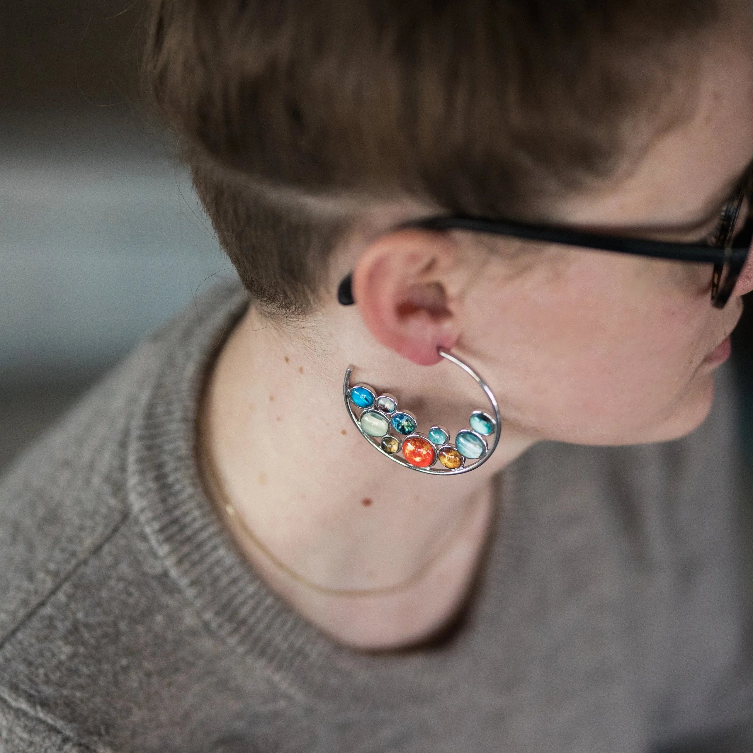Woman wearing cosmic-inspired colorful statement earring from Qu!rk Boutique