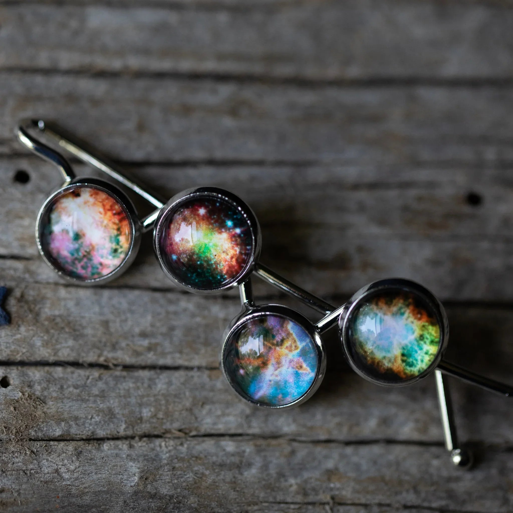 Cosmic galaxy hairpin with glass cabochons on rustic wood, Qu!rk Boutique accessory