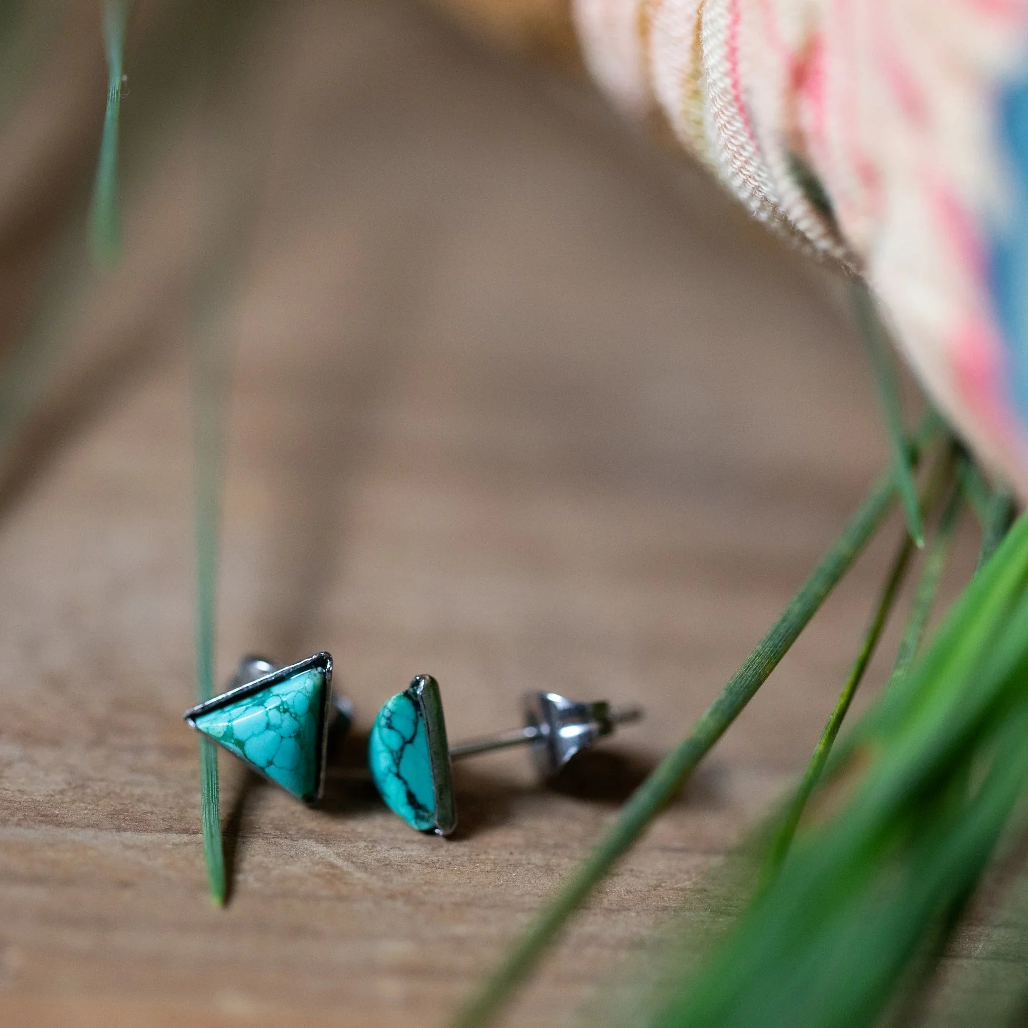 Triangle turquoise stud earrings on wood, Qu!rk Boutique artist-designed jewelry