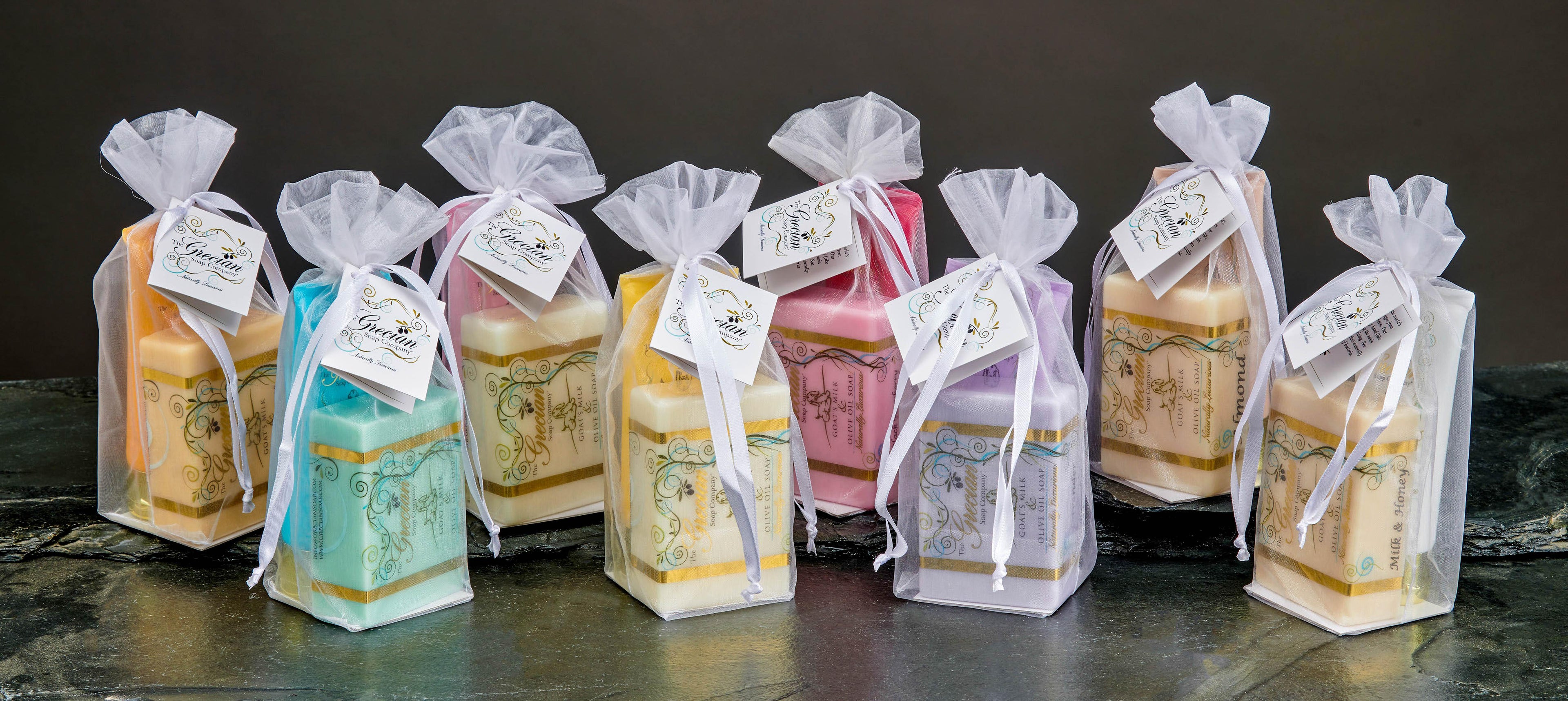 Grecian Soap Company luxury goat milk olive oil soaps in assorted colors, packaged in white organza gift bags