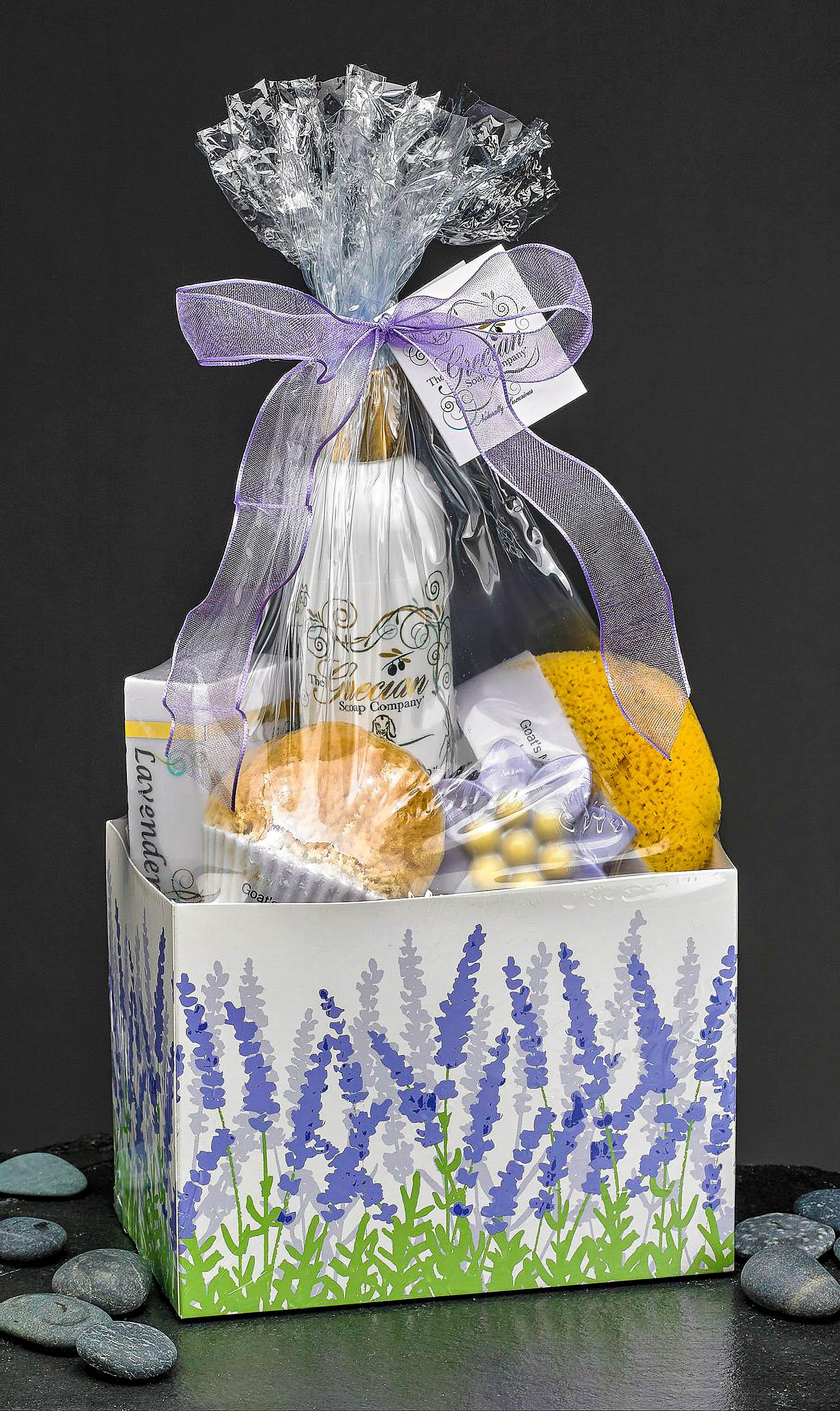 Lavender-themed gift box with soap, sponge, and bath items wrapped in clear plastic with purple bow
