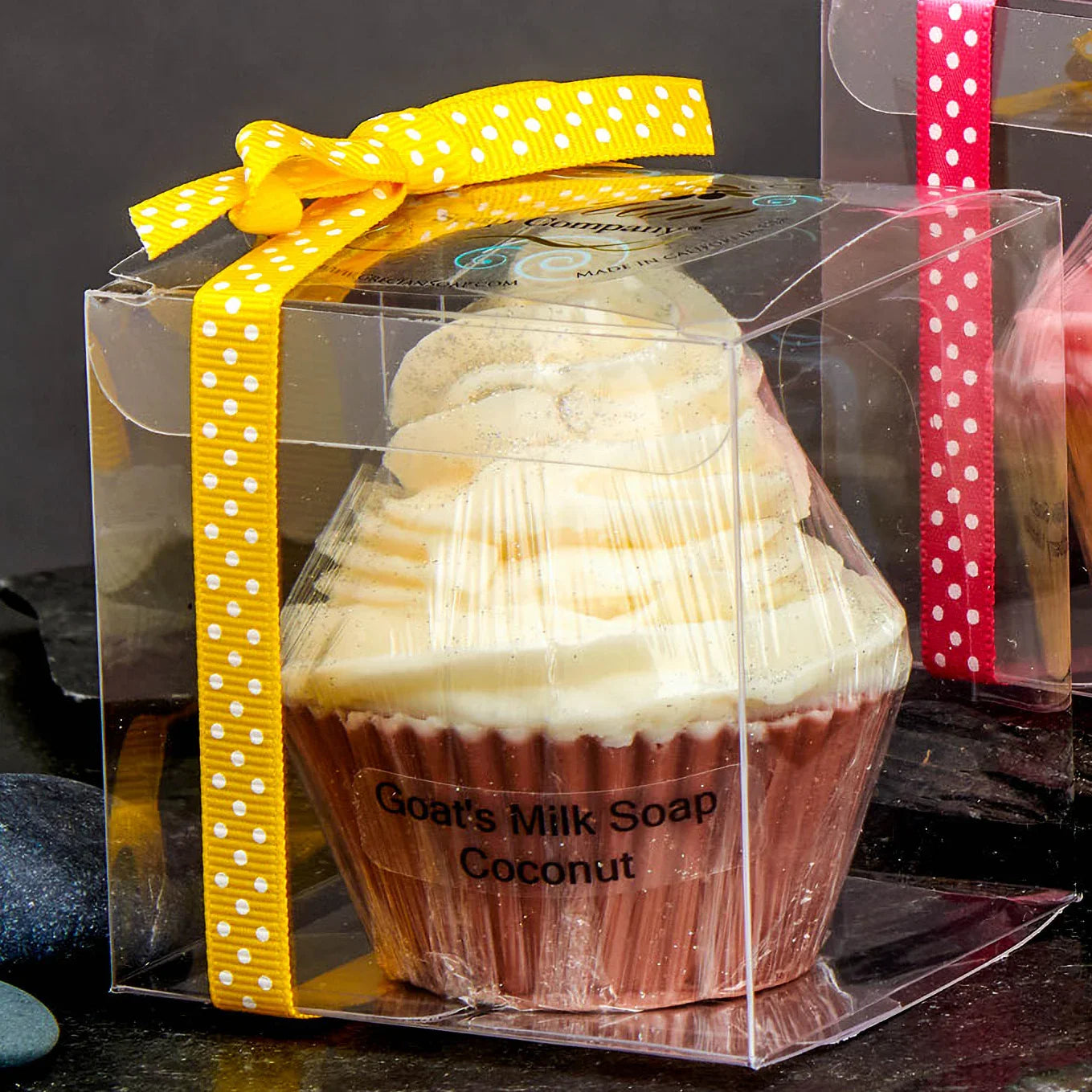 Goat's milk coconut soap shaped like a cupcake in clear box with yellow polka dot ribbon