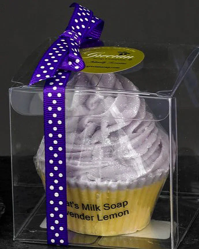 Lavender lemon goat's milk soap in cupcake shape, packaged in clear box with purple polka dot ribbon