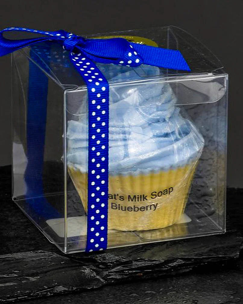 Goat's milk blueberry soap shaped like a cupcake in clear box with blue polka dot ribbon