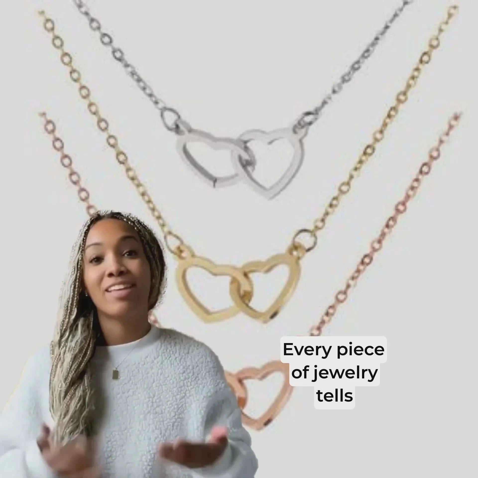 Woman presenting gold, silver, and rose gold heart-shaped linked necklaces with text Every piece of jewelry tells