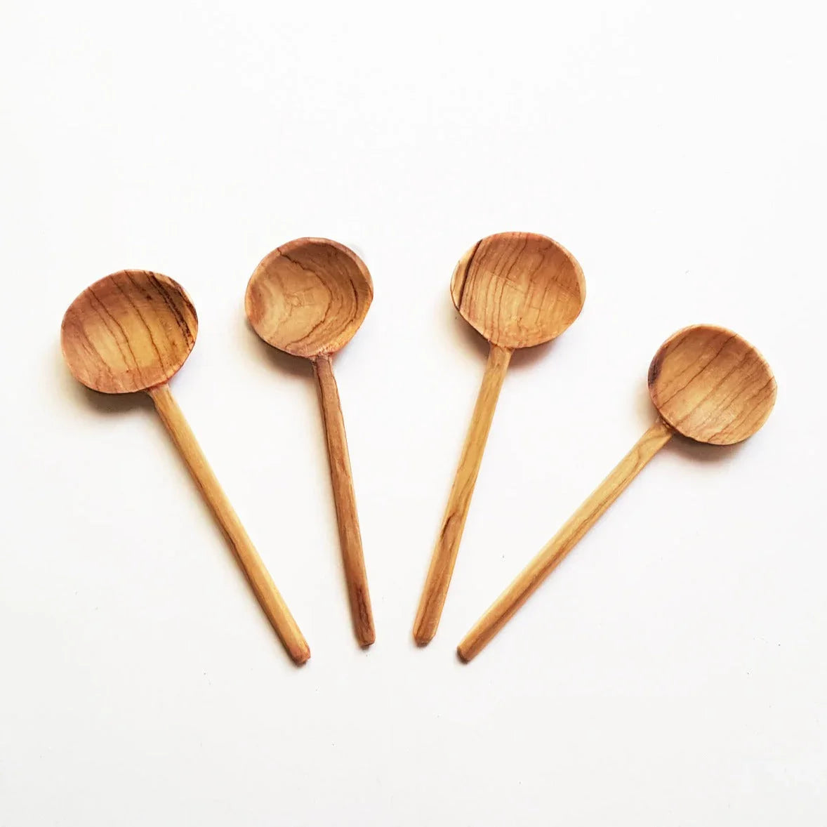 Set of four handcrafted wooden spoons on white background, Qu!rk Boutique sustainable gift