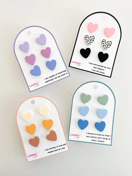 Affirmation heart earrings set in pastel and bold colors, displayed on cards with positive quotes from Qu!rk Boutique.